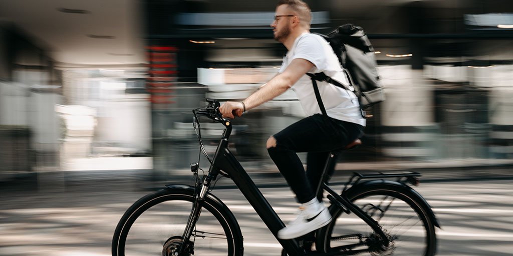 A man cycling an e-bike.
